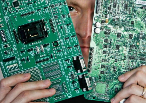 Security researcher Charlie Miller holds two automobile electronic control module circuit boards while posing in his home-office in Wildwood, Missouri, April 30, 2013. Miller, who previously worked for the National Security Agency (NSA), is a security researcher at Twitter. Picture taken April 30, 2013. To match Special Report USA-CYBERWEAPONS/ / REUTERS/Sarah Conard (UNITED STATES- - Tags: CRIME LAW SCIENCE TECHNOLOGY)